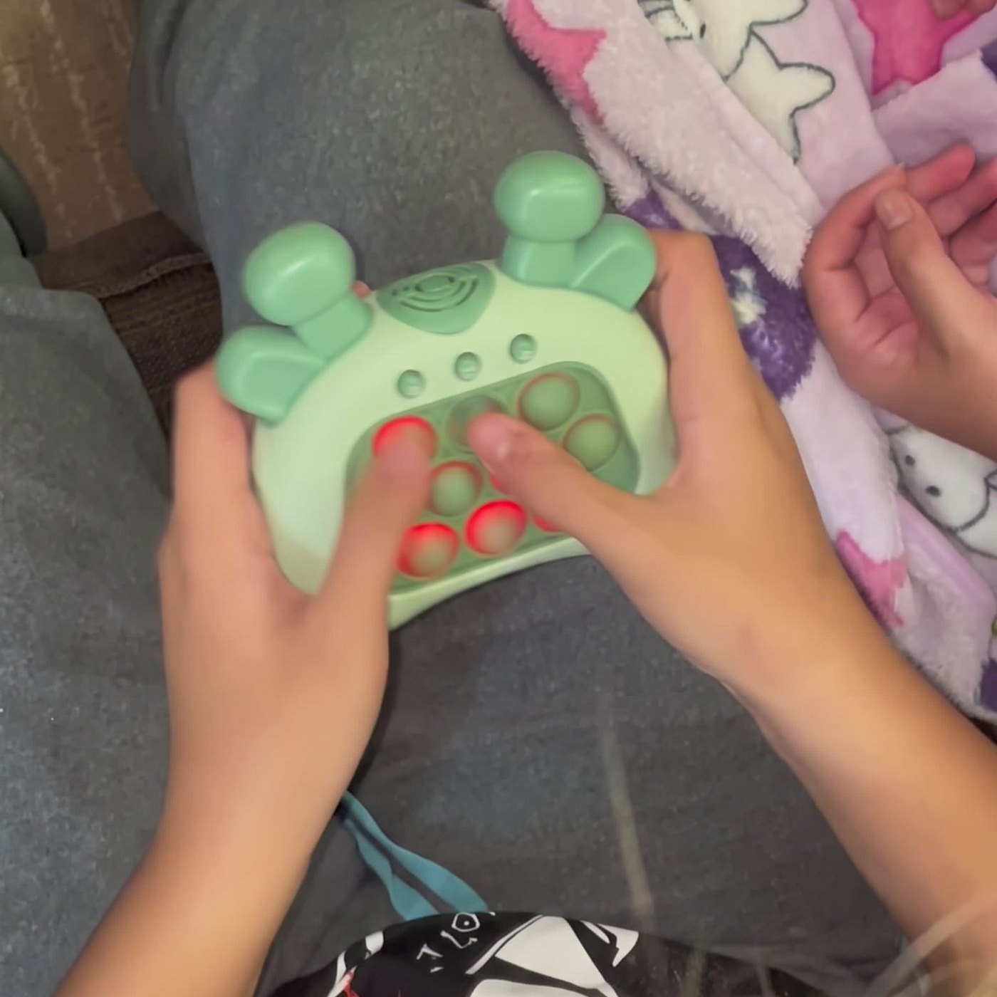 Two pairs of hands around the green push game